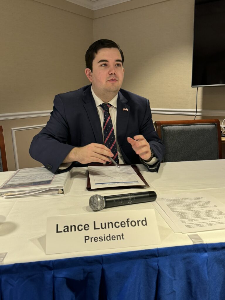 President Lance Lunceford congratulating the candidates after the forum from the dais